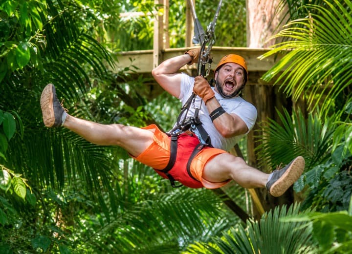 Guest ziplining through the Belize rainforest on Cave Tubing and Zipline from San Pedro