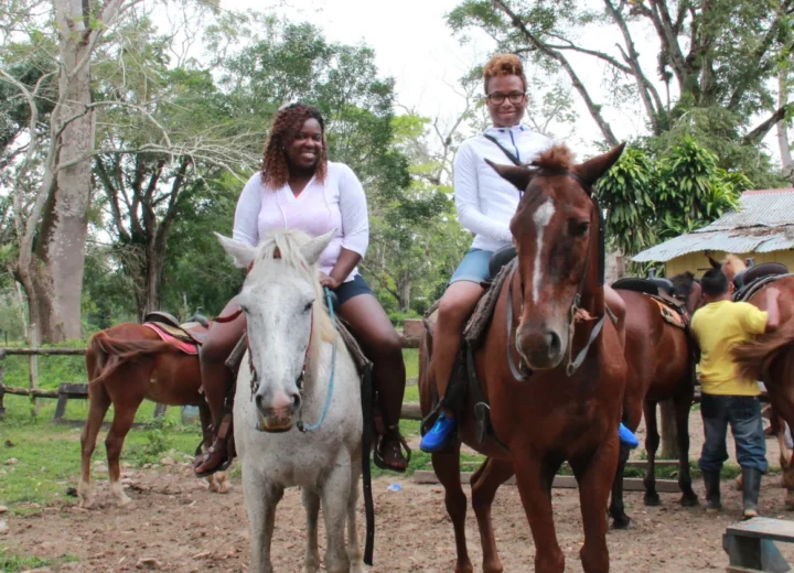 Guests beginning a Belize horseback ride on a Xunantunich tour from San Pedro