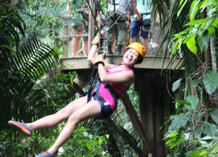 Guest enjoying a Belize jungle zipline on a Xunantunich adventure from Placencia
