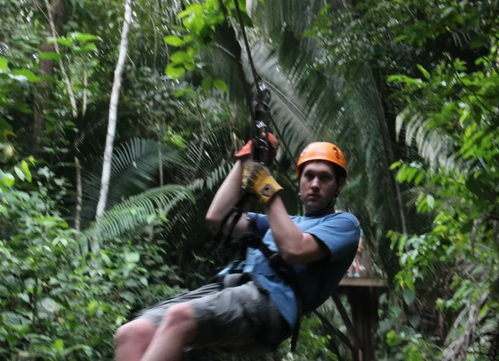 Guest ziplining through the jungle on a Xunantunich adventure from Hopkins