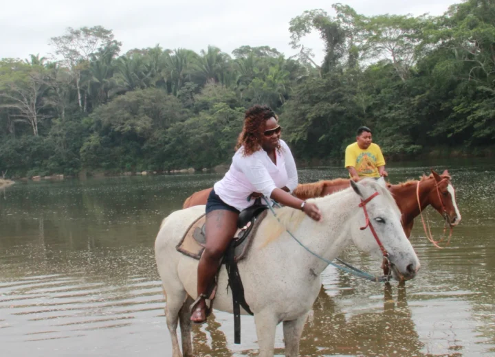 Guests horseback riding in Belize on a Xunantunich tour from Caye Caulker