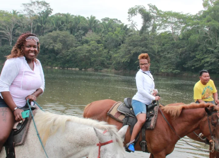 Guests on a guided horseback ride during a Xunantunich tour from San Ignacio