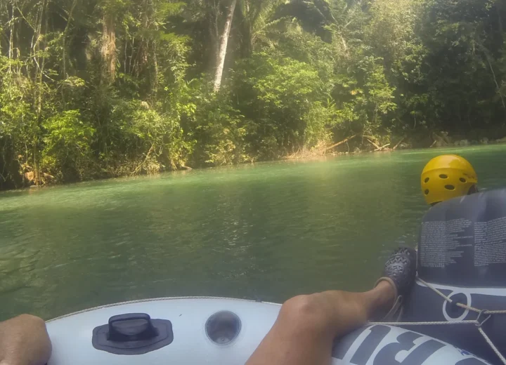 Guest relaxing on clear Belize water during a Xunantunich and Inland Blue Hole tour from Hopkins