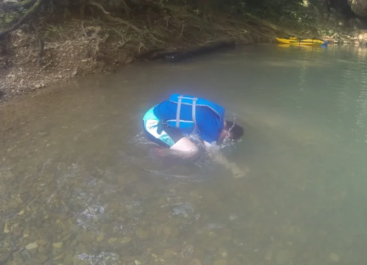 Guest floating in a Belize river on a Xunantunich river tour from Hopkins