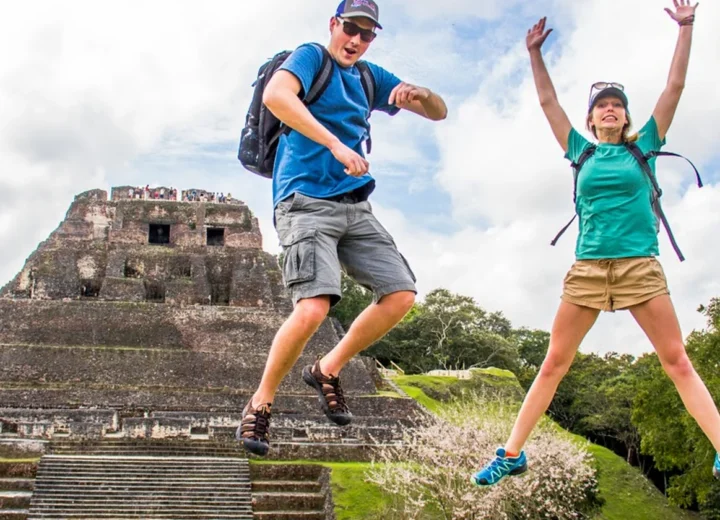 Travelers celebrating at Xunantunich Maya ruins on a private tour from Belize City