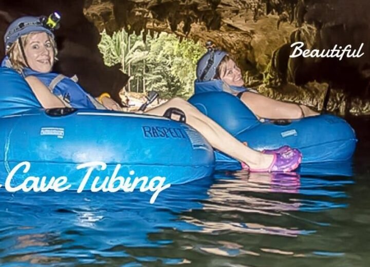 Guests cave tubing in Belize with helmets and tubes