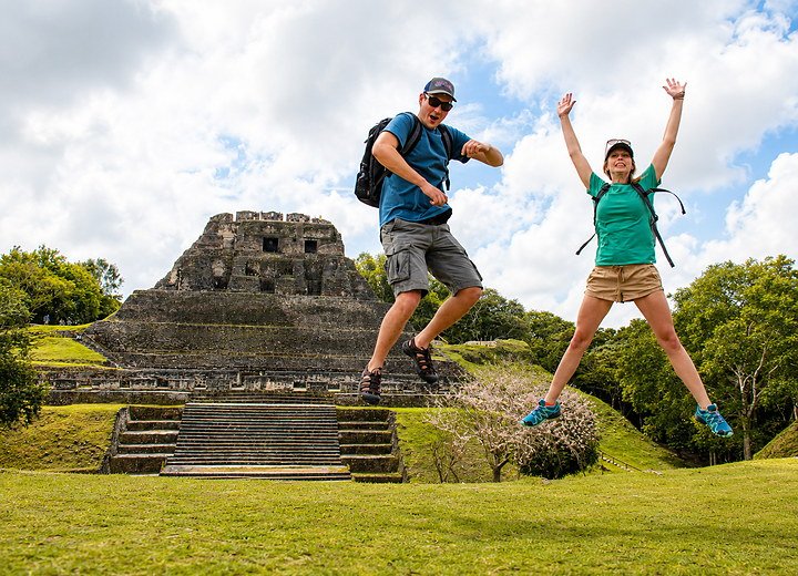 Travelers celebrating at Xunantunich Maya ruins on a Belize tour