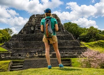 Traveler standing before El Castillo at Xunantunich Maya ruins in Belize