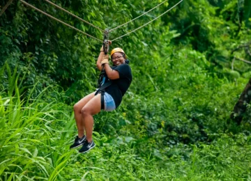 Guest ziplining through the Belize jungle